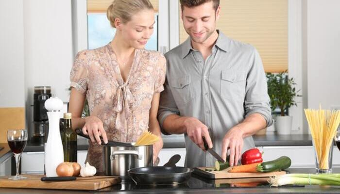 Pareja joven cortando vegetales